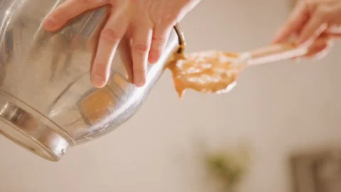 Kitchen mixing process. Preparing pumpkin batter carefully and precisely. Gently Stock Footage 348302461
