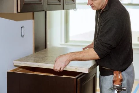 Kitchen more functional with a sink, cooktop, and partially insrall top kitch Foto stock