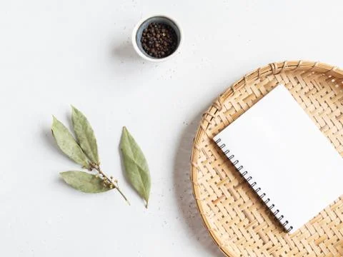 Kitchen notepad mock up for culinary text on wicker tray and spices on light  Stock Photos