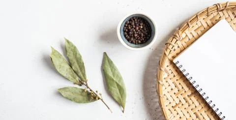 Kitchen notepad mock up for culinary text on wicker tray and spices on a ligh Stock Photos