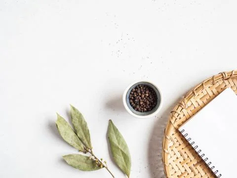 Kitchen notepad mock up for culinary text on wicker tray and spices on light  Stock Photos