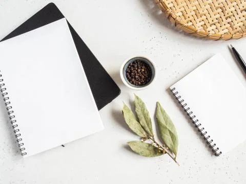 Kitchen notepad mock up for culinary text, wicker tray and spices on light ba Stock Photos