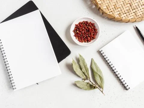 Kitchen notepad mock up for culinary text, wicker tray and spices on light ba Stock Photos