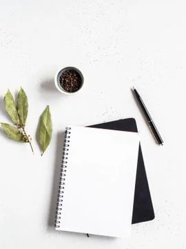 Kitchen notepad mock up for culinary text on black cookbook and spices on lig Stock Photos