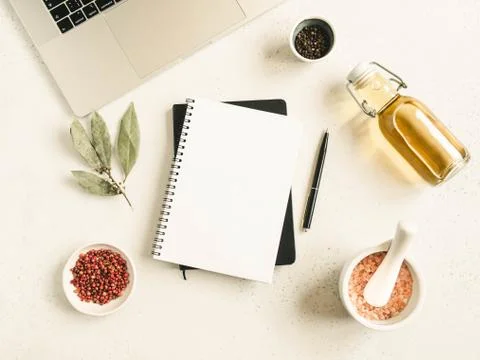 Kitchen notepad mockup for culinary text, laptop, oil in bottle and spices on Stock Photos