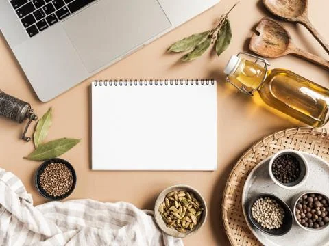 Kitchen notepad mockup for culinary text, laptop, oil in bottle and spices on Stock Photos