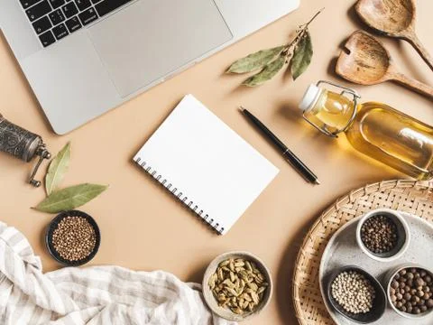 Kitchen notepad mockup for culinary text, laptop, oil in bottle and spices on Stock Photos
