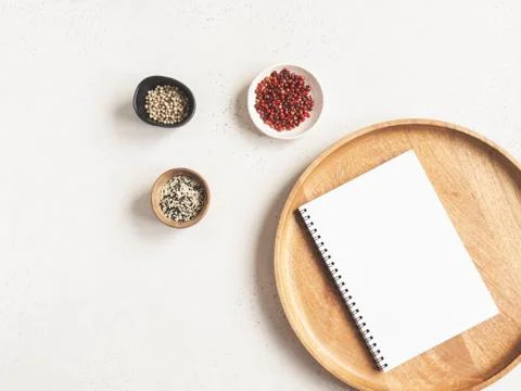Kitchen notepad mockup for culinary text on wood tray and spices on light bac Stock Photos