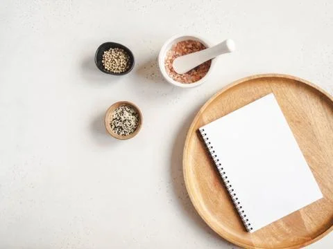 Kitchen notepad mockup for culinary text on wood tray and spices on light bac Stock Photos
