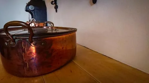 Kitchen of the old castle. Copper pans, baking molds and other kitchen utensi Stock Photos
