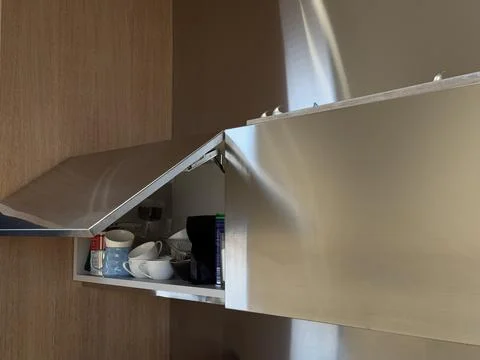 Kitchen open cabinet with jars inside Stock Photos