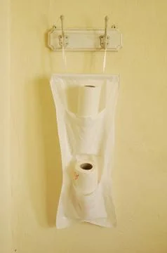 Kitchen paper in special pockets hanging on kitchen's wall Stock Photos