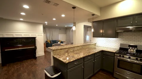 Kitchen peninsula with granite counter and gas stove Stock Footage 345690640