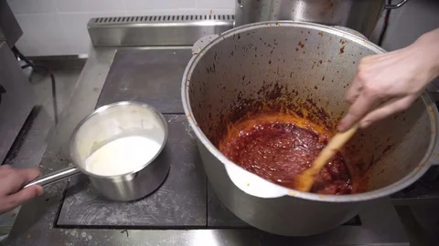 In the kitchen, at the plate two people prepare different sauces Stock Footage 71532871