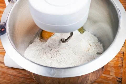 Kitchen processor kneads flour with egg 스톡 사진