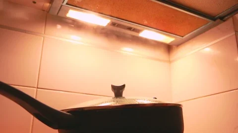 Kitchen range hood pulls the steam during cooking. Air exhauster kitchen fan Stock Footage 87509304