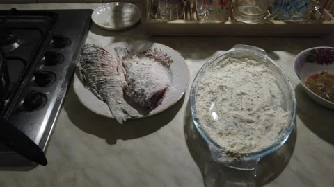 Kitchen. Raw fish on the table. The fish is fried. Ready-fired fish. Dinner. Video stock 169492828