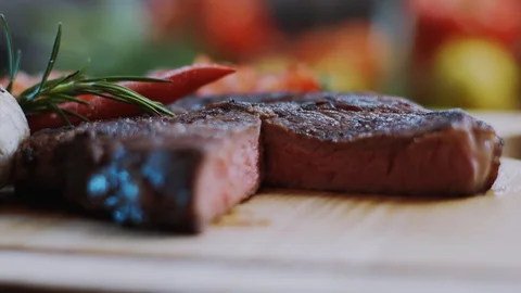In kitchen red beef steak cooked medium well cut sliced knife on a cutting board Stock Footage 100304658