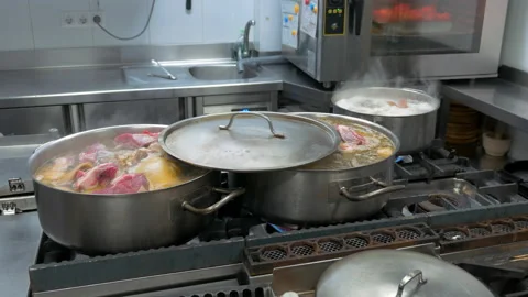 Kitchen in restaurant with boiling pots cooking stew Stock Footage 148992179