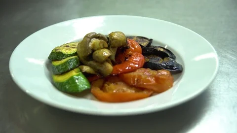 Kitchen. Restaurant. Cooking. A chef decorates a topping of grilled vegetables Stock Footage 73954709