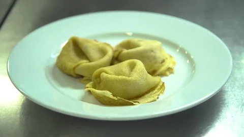 Kitchen. Restaurant. Cooking. The chef decorates pancakes blueberry jam Stock Footage 73954848