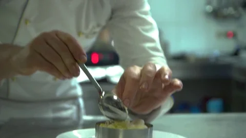 Kitchen. Restaurant. Cooking. A chef decorates a corn porridge with sheep's Stock Footage 73954953