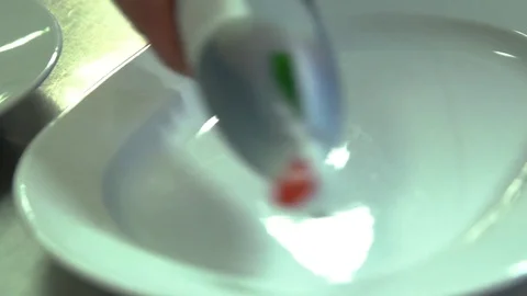 Kitchen. Restaurant. Cooking. The chef puts toppings on a plate Stock Footage 73954593