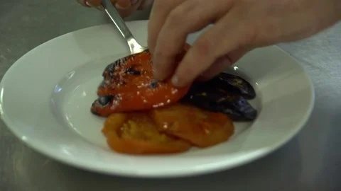 Kitchen. Restaurant. Cooking. The chef puts the grilled vegetables on a plate Stock Footage 73954640