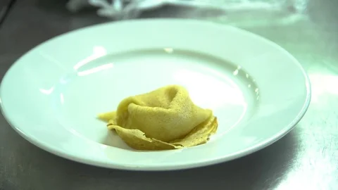 Kitchen. Restaurant. Cooking. The chef puts the pancakes on a plate Stock Footage 73954815