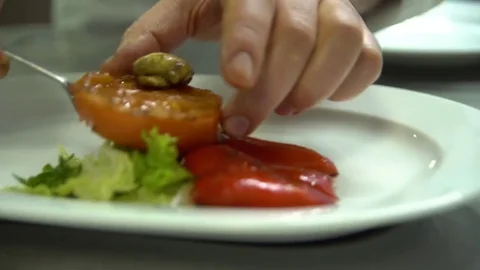Kitchen. Restaurant. Cooking. The chef puts the grilled vegetables on a plate Stock Footage 73955241