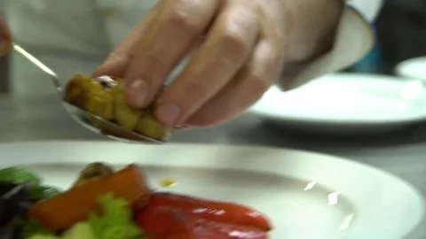 Kitchen. Restaurant. Cooking. The chef puts the grilled vegetables on a plate Stock Footage 73955268