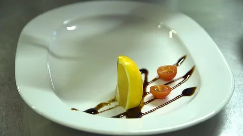 Kitchen. Restaurant. Cooking. Chef is putting the fish on the plate Stock Footage 73954606
