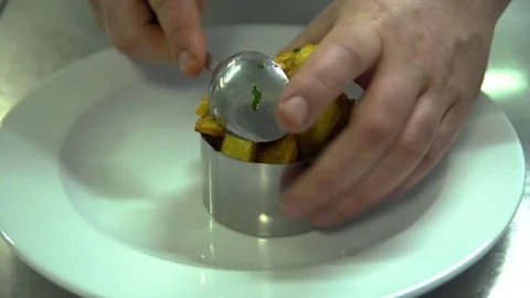 Kitchen. A restaurant. Cooking. Cook puts the french fries on the dish Stock Footage 73954985