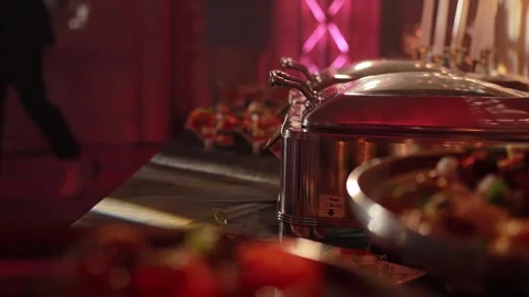 Kitchen in a restaurant with ready-made dishes on the table and hot food in a Stock Footage 296579297