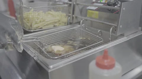 The kitchen of a restaurant in San José, Costa Rica; french fries Video stock 344340686