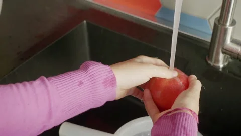 Kitchen Rituals: Hands Engage in Apple Cleansing Video stock 271299530