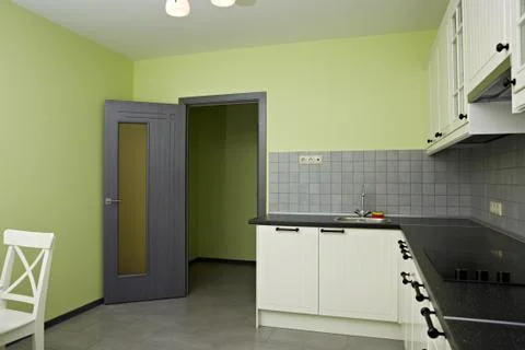 Kitchen room with exit. White wood kitchen unit Stock Photos
