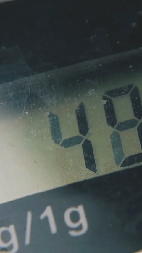 Kitchen scales with screen shows weight extreme close view Stock Footage 317418939