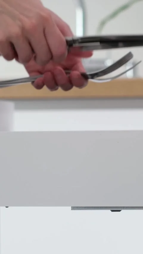 Kitchen scene showcasing a person reaching into a drawer filled with cutlery Stock Footage 315660958