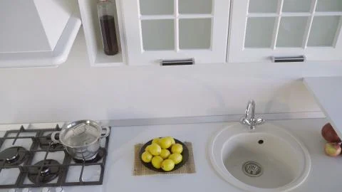 Kitchen set. White kitchen set. A plate with lemons is standing on the counte Stock Photos