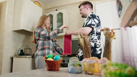 Kitchen setting showcases affectionate gift giving during Easter celebration 库存影片 330498139
