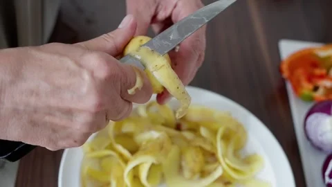 Kitchen setup with vegetables and cutting actions, chef skillfully chopping Stock Footage 322809582