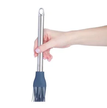 Kitchen silicone brush in hand Stock Photos