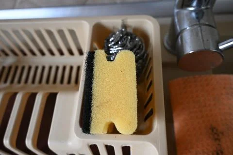 Kitchen sink dish rack with sponge Stock Photos
