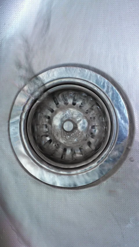 Kitchen sink drain strainer covered by rising water during cleaning Video stock 344978513