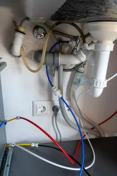 Kitchen sink drainage system with connected water filter tubing Photos