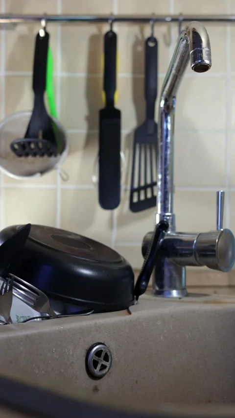 A Kitchen Sink Filled With Various Dishes And Utensils. Vertical. Stock Footage 294320618