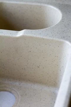 Kitchen sink from a light artificial stone on two bowls. Stock Photos