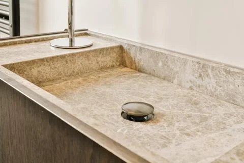 A kitchen sink with a soap dispenser in it Stock Photos