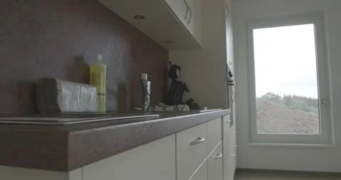 Kitchen Sink With Tap and Dish Soap on a Worktop, Bright Interior, Slow Close Up Stock Footage 340360627